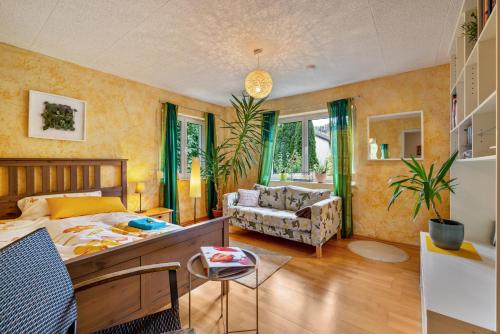 a bedroom with a bed and a living room at Schönes Zimmer mit eigenem Bad in Albstadt
