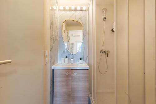 a bathroom with a sink and a mirror at Charming 2 bedroom House With Pool in Eyguières