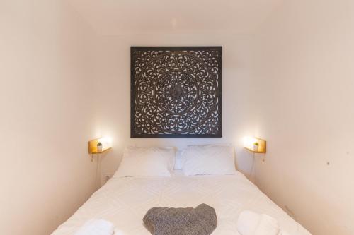 a bedroom with a bed with a picture on the wall at Charming 2 bedroom House With Pool in Eyguières