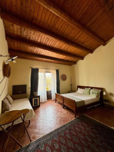 a bedroom with two beds and a table and a couch at Oasi di relax in Noto