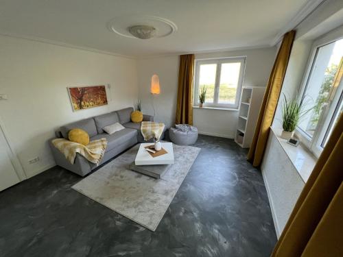a living room with a couch and a table at Ferienwohnung Karbachtal in Wangen im Allgäu