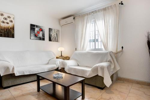 a living room with two white couches and a table at Vejer 1 - Andalmar in Vejer de la Frontera
