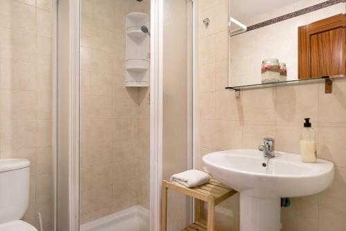 a bathroom with a sink and a toilet and a shower at Vejer 1 - Andalmar in Vejer de la Frontera