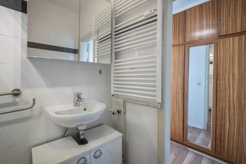 a white bathroom with a sink and a mirror at Braunlageblick in Braunlage