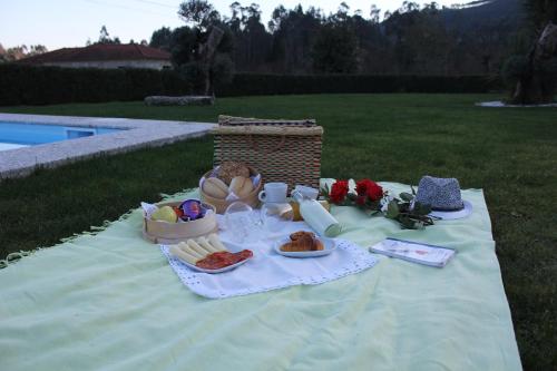 a picnic table with bread and food on it at Casa do Sobreira in Vieira do Minho