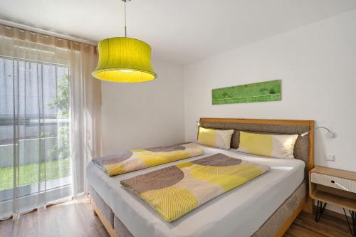 a bedroom with a bed and a large window at Wohlfühlhaus in Freiamt
