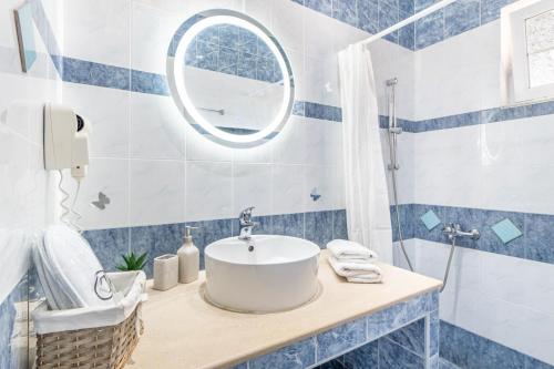 a bathroom with a sink and a mirror at Spyridoula Studio 3 in Paleokastritsa