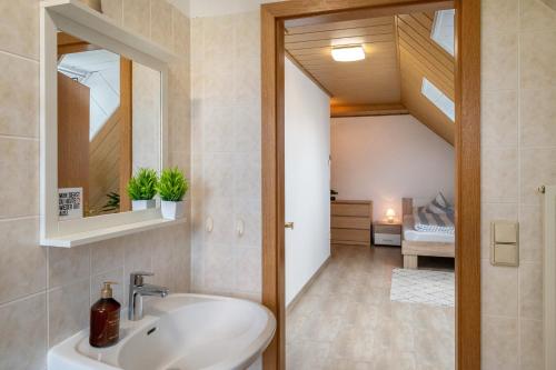 a bathroom with a sink and a mirror at Ferienwohnung An der Haferkoppel in Groß Kussewitz