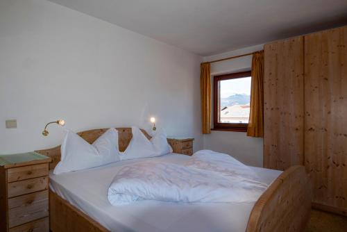 a bedroom with a white bed with a window at Apartment 7 - Zur Sonne in Laion