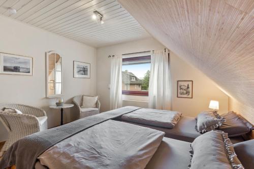 a bedroom with a large bed and a window at Ferienwohnung Am Orpeturm in Marsberg