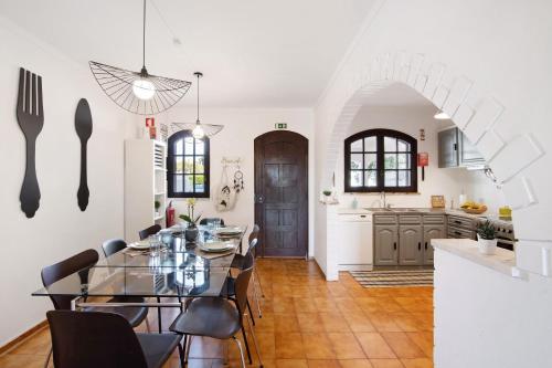 a kitchen and dining room with a table and chairs at Altura Beach Villa in Altura