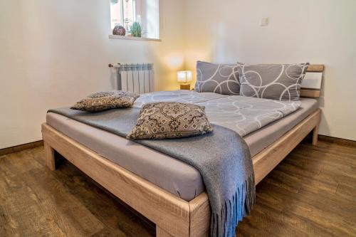 a bed with two pillows on it in a room at Wohnung 2 in Wallhausen