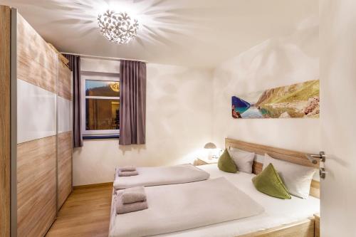 a bedroom with a bed and a chandelier at Ferienwohnung Viadukt in Willingen