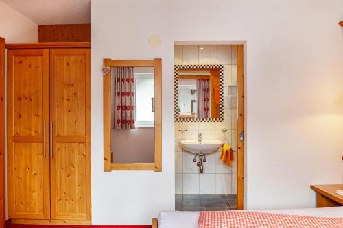 a bathroom with a sink and a mirror at Alpenflora 1 in Ischgl