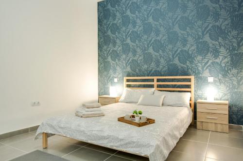 a bedroom with a bed with a tray of towels on it at 2b El Amore in Vecindario