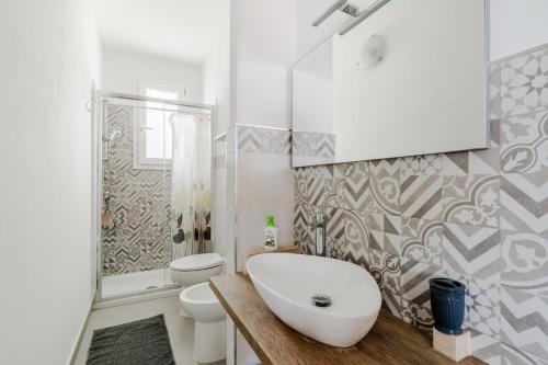a white bathroom with a sink and a toilet at Donasand_torre san giovanni in Torre San Giovanni Ugento