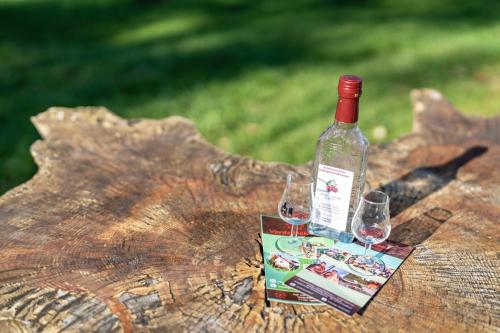a bottle of wine sitting on top of a tree stump at Trekking Camp am Renchtalsteig in Oppenau