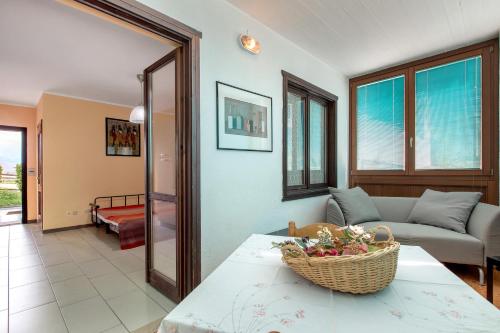 a living room with a couch and a basket on a table at Casa D'Agostino in Aosta