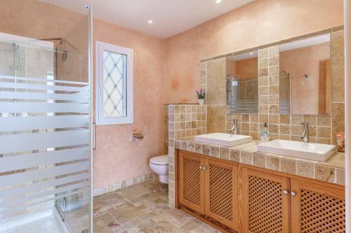 a bathroom with a toilet and a sink and a shower at Villa Almeda in Port d'Andratx