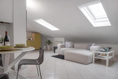 a living room with a couch and a table at Mansarda Massimo - Verbania Intra in Verbania