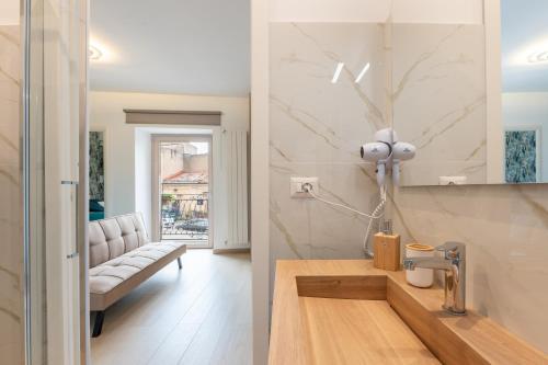a kitchen and a living room with a couch at Vico degli Orti in Mistretta