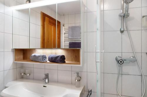 a bathroom with a sink and a mirror at Apart Löffler in Kappl