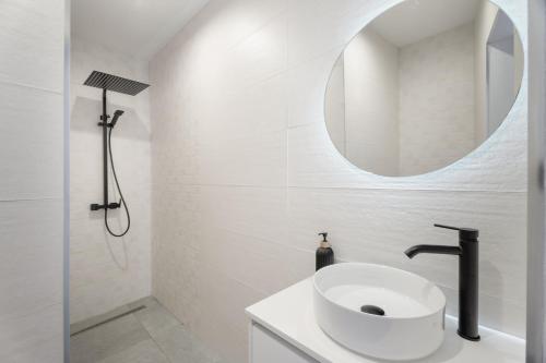 a white bathroom with a sink and a mirror at Buena - Vista in La Guancha