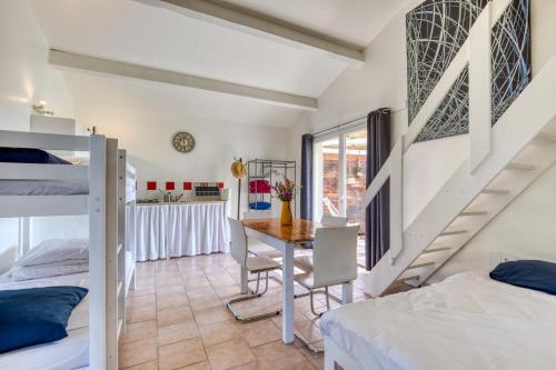 a bedroom with a bed and a table and chairs at Mas des Cypres - Mazet 5 in Saintes-Maries-de-la-Mer