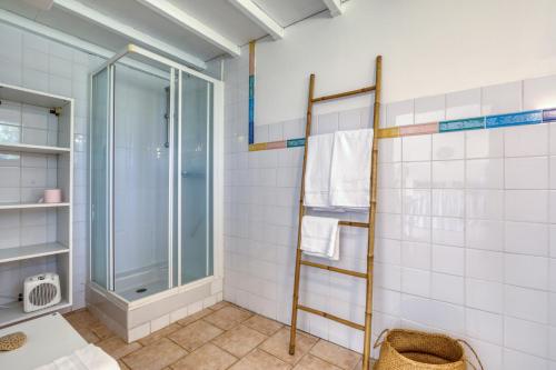 a bathroom with a shower and a glass door at Mas des Cypres - Mazet 5 in Saintes-Maries-de-la-Mer