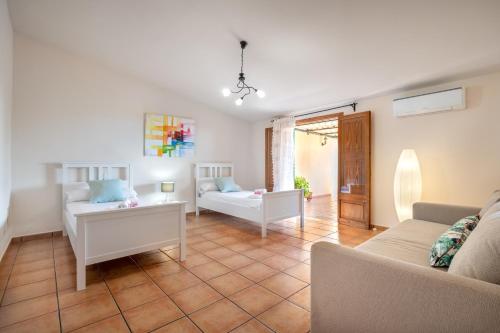 a living room with a couch and a table at Villa Ca Na Campins in Campanet