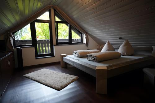 a room with a bed with pillows on it at Ferienhaus zum Frankenblick in Sonneberg