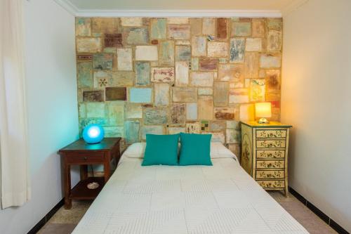 a bedroom with a bed and a brick wall at Casa de Gertrudis in El Palmar