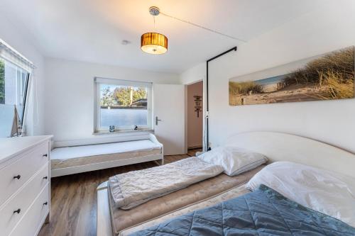 a bedroom with two beds and a window at Insel Koje 1 in Fehmarn