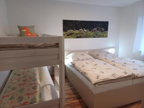 a bedroom with two beds and a bunk bed at Ferienwohnung Panoramablick in Bad Wildbad