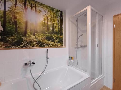 a bathroom with a shower and a painting on the wall at Ferienwohnung Panoramablick in Bad Wildbad