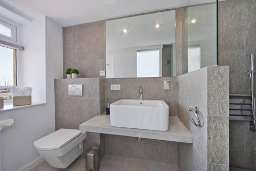 a bathroom with a sink and a toilet and a mirror at Maina 1919 in Pollença