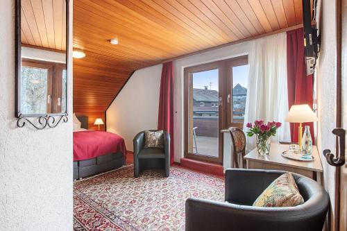 a hotel room with a bed and a window at Hotel Bären - drei Sterne in Bernau im Schwarzwald