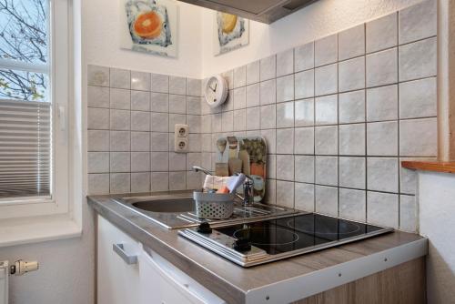 a kitchen with a sink and a counter top at Bäckerhus - Ferienwohnung 3 in Wiek auf Rügen