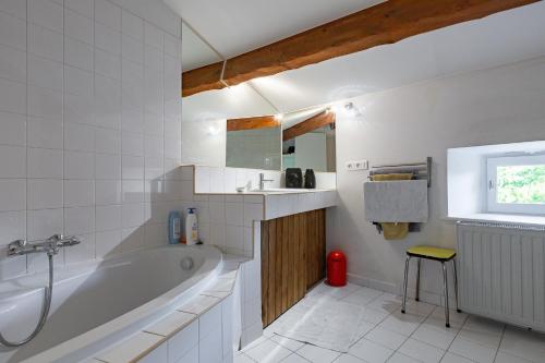 a white bathroom with a tub and a sink at Typical House Completely Renovated in Saint-Alban-dʼAy