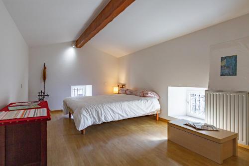 a bedroom with a bed and a wooden floor at Typical House Completely Renovated in Saint-Alban-dʼAy