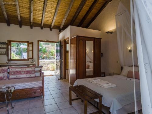 a bedroom with a bed and a bench in it at Adamantia Studio S3 in Gaios