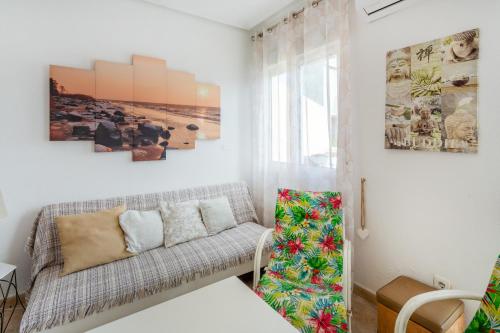 a living room with a couch and pictures on the wall at Almdna15-atc in Torrevieja