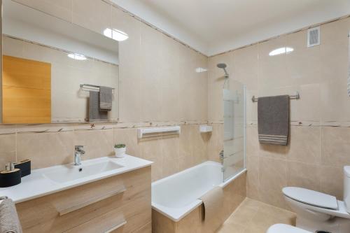 a bathroom with a sink and a tub and a toilet at Maresía in Los Abrigos