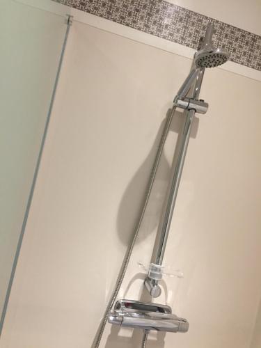 a metal towel rack hanging on a wall at Gästgivars vandrarhem och B&B in Järvsö