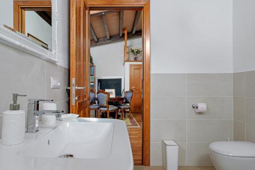 a bathroom with a sink and a toilet at Camere La Ro Ca- Telti in Telti