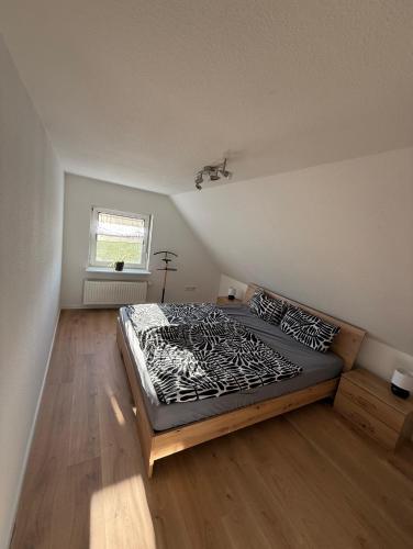 a bedroom with a large bed in a room at Ferienwohnung Waldblick Alterkülz in Alterkülz