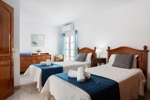 a bedroom with two beds with towels on them at Villa Muñoz in Puerto del Carmen