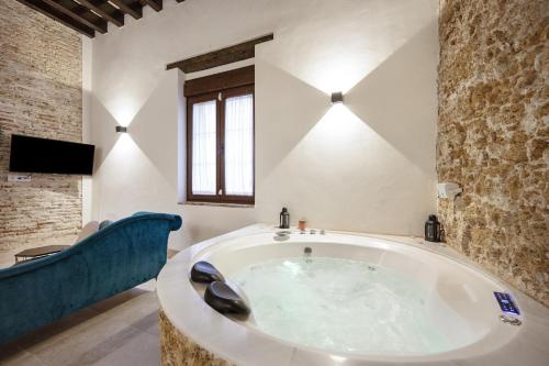 a large bath tub in a bathroom with a tv at Bella Encantada in Cádiz