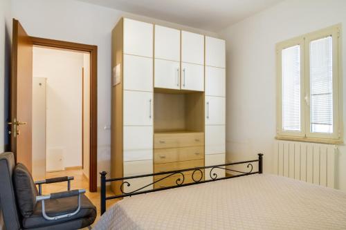 a bedroom with a bed and a chair at Acqua in Follonica
