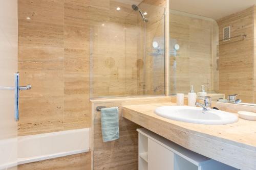 a bathroom with a sink and a shower at Mar i Llum in Platja d'Aro